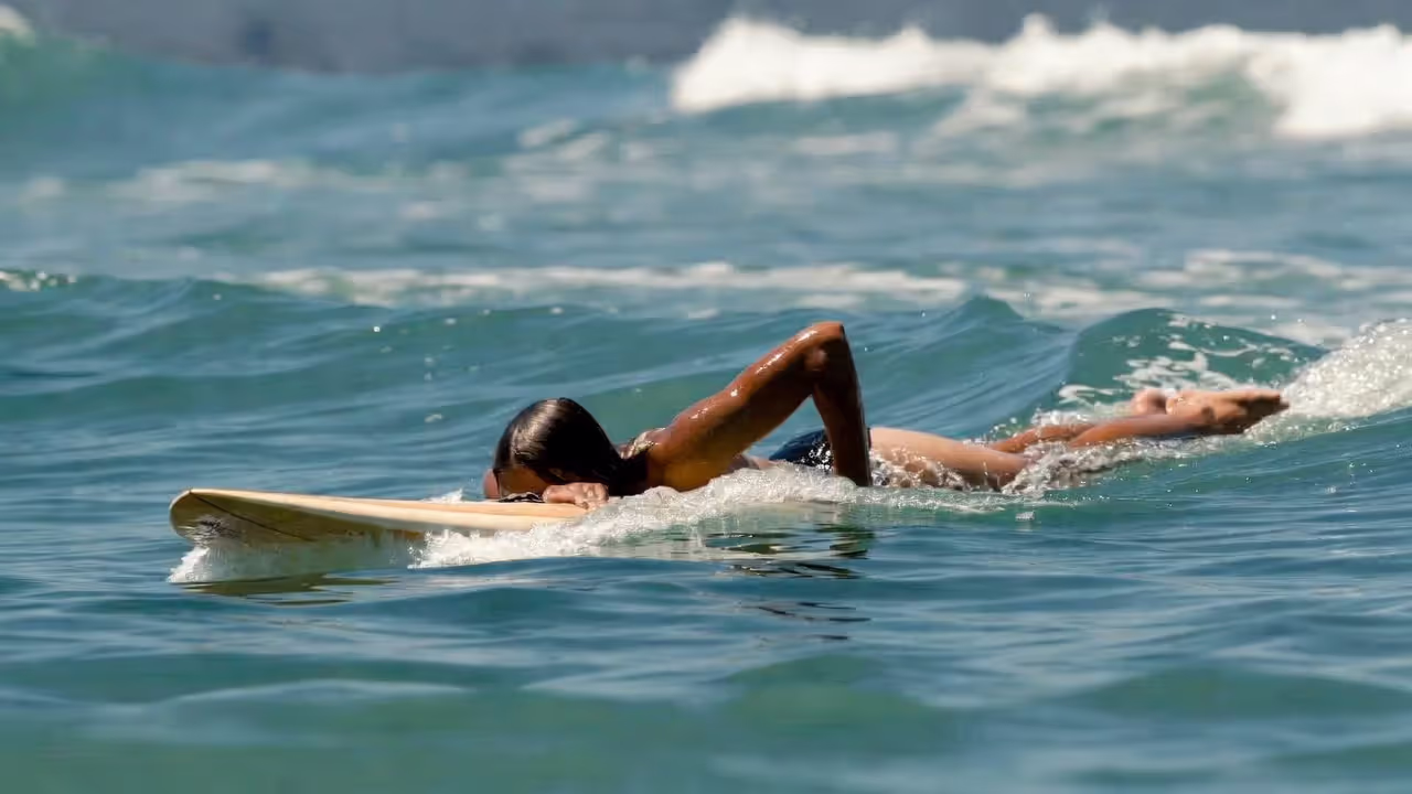 Efficient paddling technique creates the speed needed to catch waves