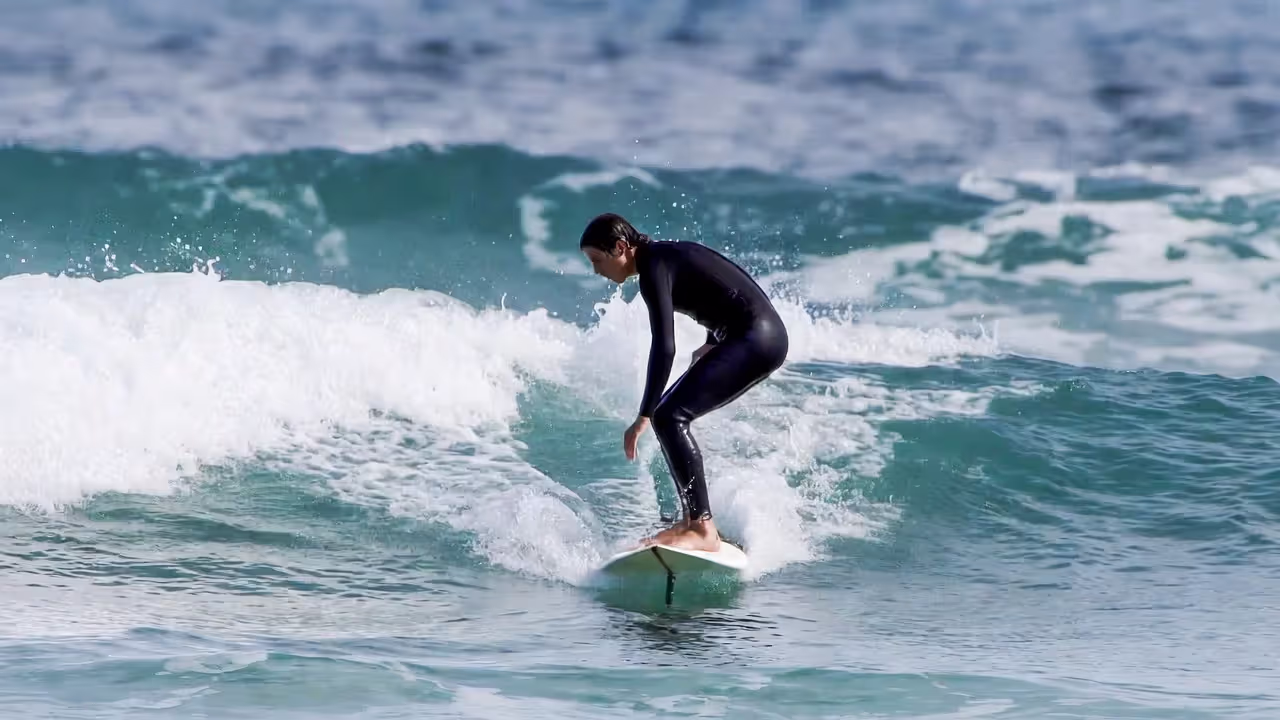 Looking down often breaks balance before the wave does